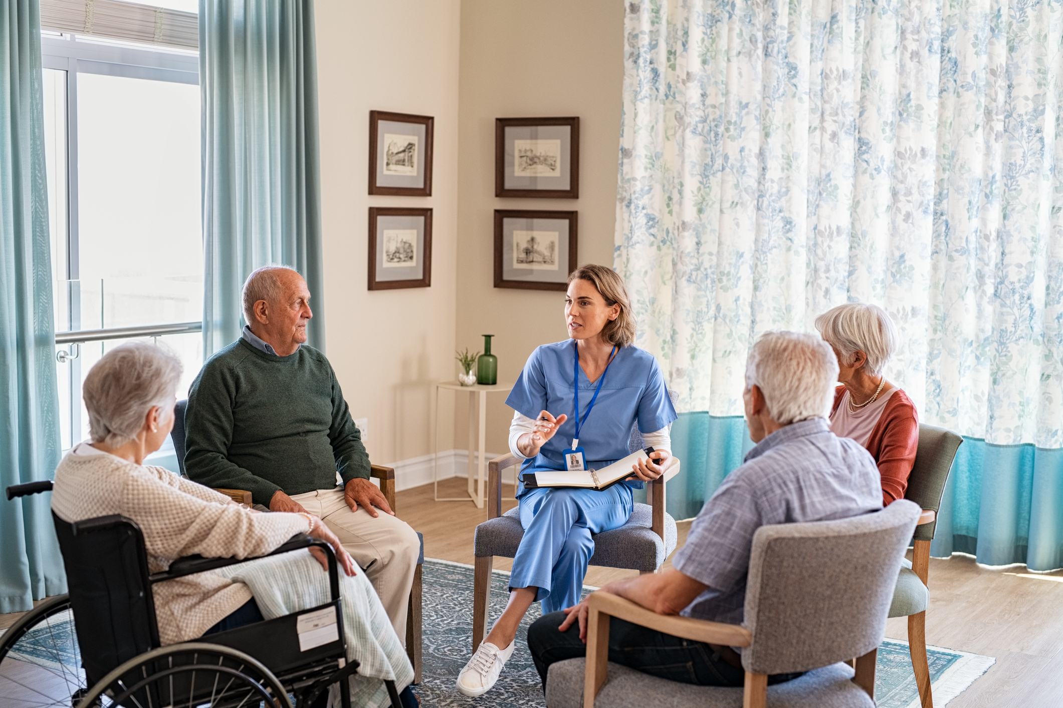 Nurse talking to senior people during group therapy