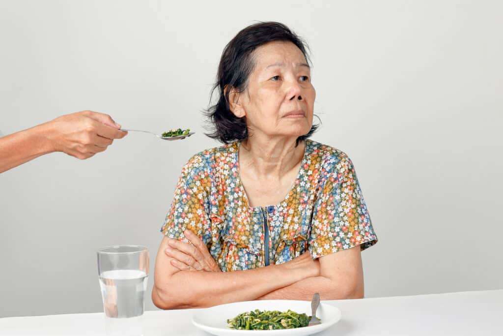 Elderly woman refusing food